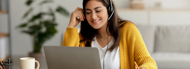 Woman wearing a headset while in a virtual setting.